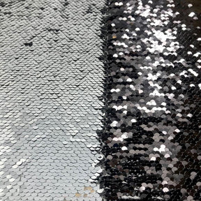 https://fabricwholesaledirect.com/cdn/shop/products/Black_Silver_Two-Sided_Reversible_Sequins_on_Stretch_Mesh_2_288x.jpg?v=1612516136